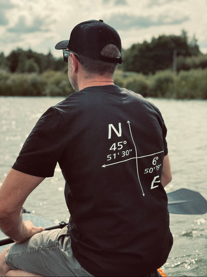 Organic Black t-shirt featuring minimalist coordinates graphic on the front, designed by Peak 2 Paddle. Lightweight, eco-friendly fabric with a relaxed fit — inspired by nature and adventure.