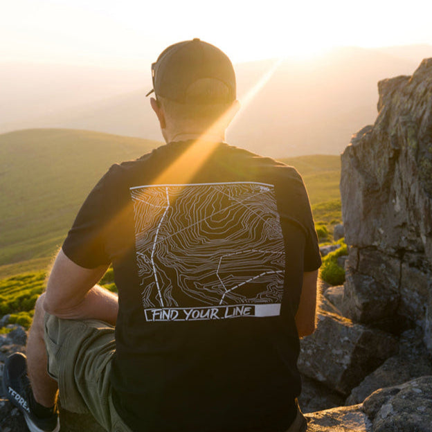 Find Your Line' mountain-inspired graphic on the back, designed by Peak 2 Paddle. Adventure-ready design printed on soft, organic cotton with a relaxed fit — made for those who follow their own path."