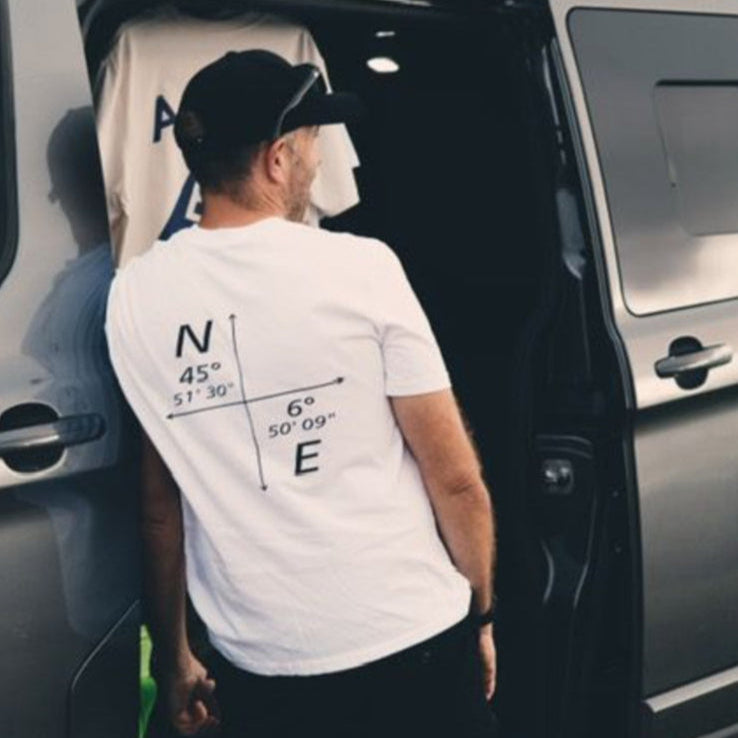 Organic white t-shirt featuring minimalist coordinates graphic on the front, designed by Peak 2 Paddle. Lightweight, eco-friendly fabric with a relaxed fit — inspired by nature and adventure.